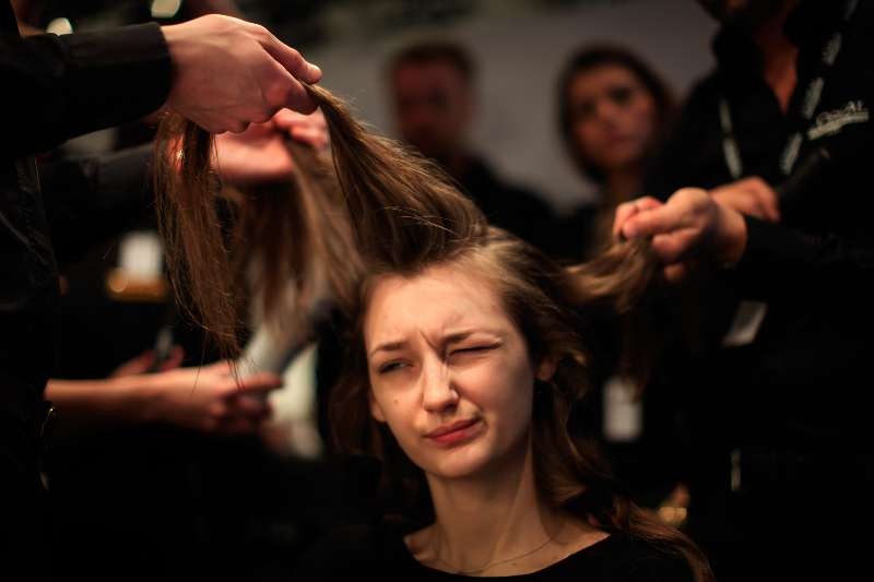 A model prepares for the display of Germany's Minx bu Eva Lutz during the Mercedes-Benz Fashion Week Berlin Autumn/Winter 2015 in Berlin, Germany