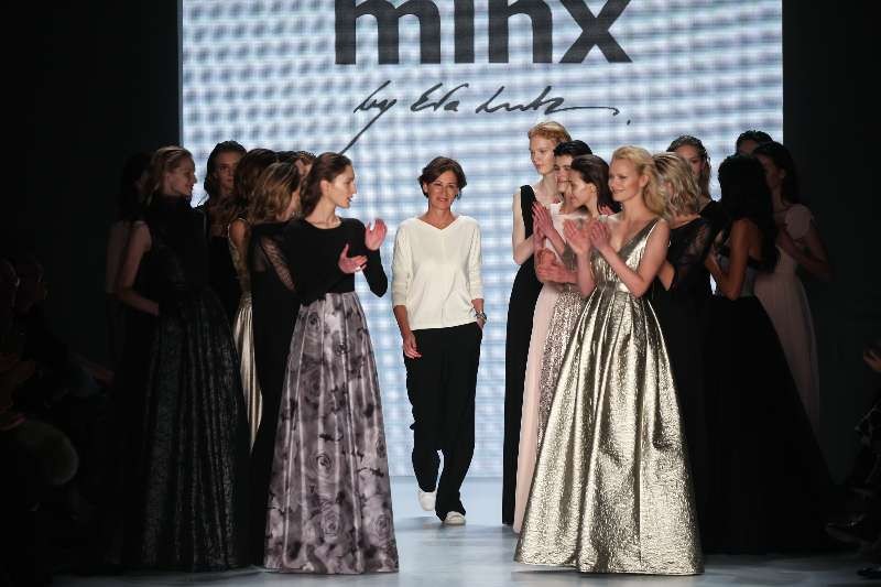 German designer Eva Lutz (C) of Germany's Minx greets the audience during the Mercedes-Benz Fashion Week Berlin Autumn/Winter 2015 in Berlin, Germany