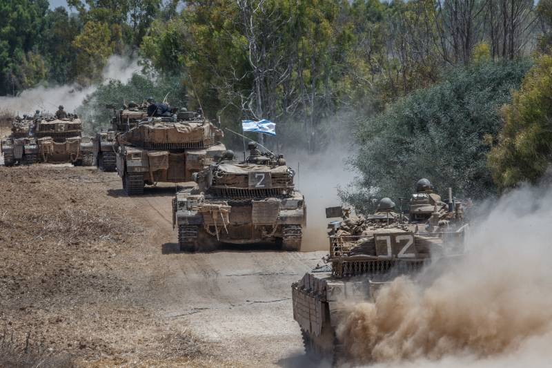 Israeli Markava tanks run in southern Israel near the border with Gaza