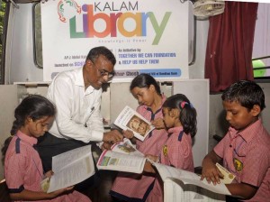 Bandhan Bank Managing Director Chandra Shekhar Ghosh with children on "Kalam Library on Wheels" in Kolkata (Photo: IANS)