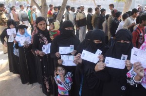 Muslim women stand in a queue to cast their vote in the first phase of the Uttar Pradesh assembly elections in Mathura (Photo: IANS)