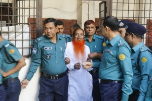 Dhaka: Police escort a member of a banned terror outfit Jamaat-ul-Mujahideen Bangladesh after he was sentenced to death for an attack on a Dhaka's Holey Artisan Bakery that killed more than 20 people in Dhaka, Bangladesh on Nov 27, 2019. (Photo: bdnews24/IANS)