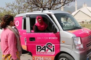 (180308) -- ISLAMABAD, March 8, 2018 (Xinhua) -- A female driver talks with a customer during a launching ceremony of the women-only Pink Taxi in Islamabad, capital of Pakistan, on March 8, 2018. A taxi service only for women was launched in Islamabad to celebrate the International Women's Day. (Xinhua/Ahmad Kamal) (zy)