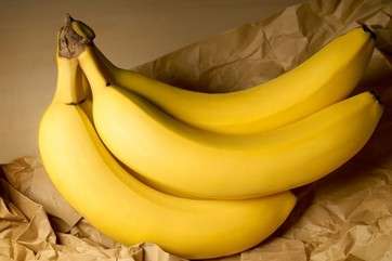 Bananas on brown paper bag