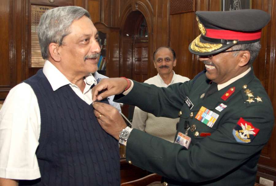 New Delhi: The Secretary, Kendriya Sainik Board, Brig. M.H. Rizvi pins a lapel on the Union Minister for Defence Manohar Parrikar on the occasion of the Armed Forces Flag Day, in New Delhi on Dec 7, 2016. (Photo: IANS/PIB)