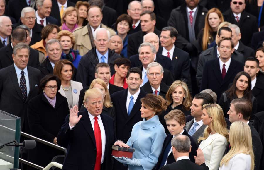 WASHINGTON, Jan. 20, 2017 (Xinhua) -- U.S. President Donald Trump(1st L, front row) takes the oath of office during the presidential inauguration ceremony at the U.S. Capitol in Washington D.C., the United States, on Jan. 20, 2017. Donald Trump was sworn in on Friday as the 45th President of the United States. (Xinhua/Yin Bogu/IANS) by . 