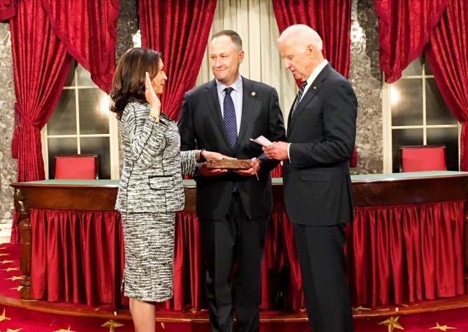 Washington: Vice President Joseph Biden administers the oath of office to Kamala Harris, thefirst Indian American elected to Senate. She swore on a Bible held by her husband Doug Emhoff, (center) in Washington D.C. on Jan 3, 2016. (Photo: Maya Harris on Twitter/IANS)