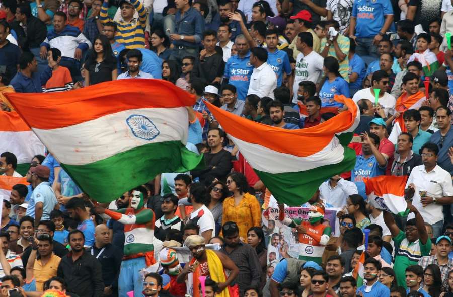 Pune: A fans of the Indian cricket team waves the national flag during the 1st ODI match between India and England at the Maharashtra Cricket Association Stadium in Pune on Jan 15, 2017. Also seen (Photo: Surjeet Yadav/IANS)