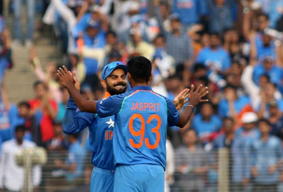 Pune: Virat Kohli and Jasprit Bumrah of India celebrate after the fall of Joe Root's wicket during the 1st ODI match between India and England at the Maharashtra Cricket Association Stadium in Pune on Jan 15, 2017. Also seen (Photo: Surjeet Yadav/IANS)