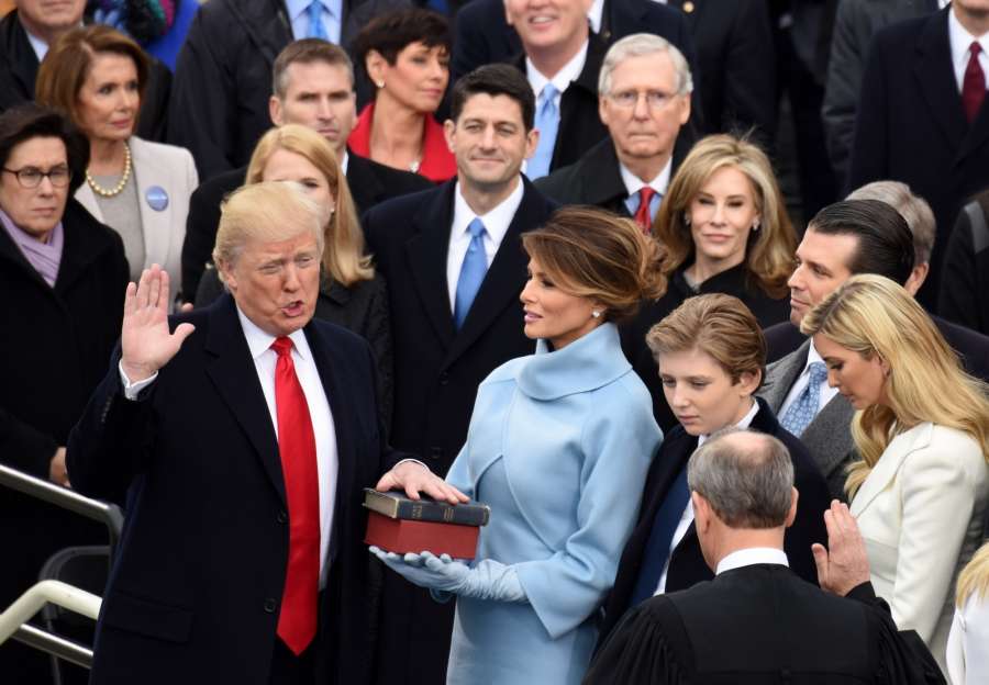 WASHINGTON, Jan. 20, 2017 (Xinhua) -- U.S. President Donald Trump(L) takes the oath of office during the presidential inauguration ceremony at the U.S. Capitol in Washington D.C., the United States, on Jan. 20, 2017. Donald Trump was sworn in on Friday as the 45th President of the United States. (Xinhua/Yin Bogu/IANS) by . 