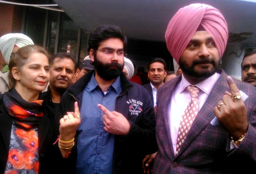 Amritsar: Congress Candidate Navjot Singh Sidhu along with his wife Navjot Kaur show forefingers marked with phosphorus ink after casting their vote at a polling station during Punjab Legislative Assembly in Amritsar, on Feb 4, 2017. (Photo: IANS) by .