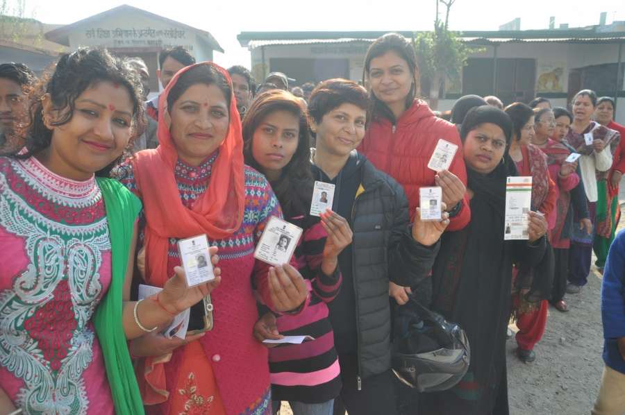 Dehradun: People stand in a queue to cast their vote for Uttarakhand assembly elections in Dehradun on Feb. 15, 2017. (Photo: IANS) by . 