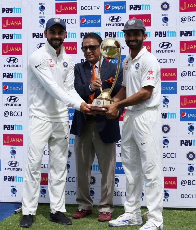 Dharamsala: Virat Kohli (L) and Ajinkya Rahane (R) of India receives Border-Gavasker Trophy from former cricketer Sunil Gavaskar (C) after winning the Test match series against Australia at Himachal Pradesh Cricket Association Stadium in Dharamsala on March 28, 2017. (Photo: Surjeet Yadav/IANS) by . 