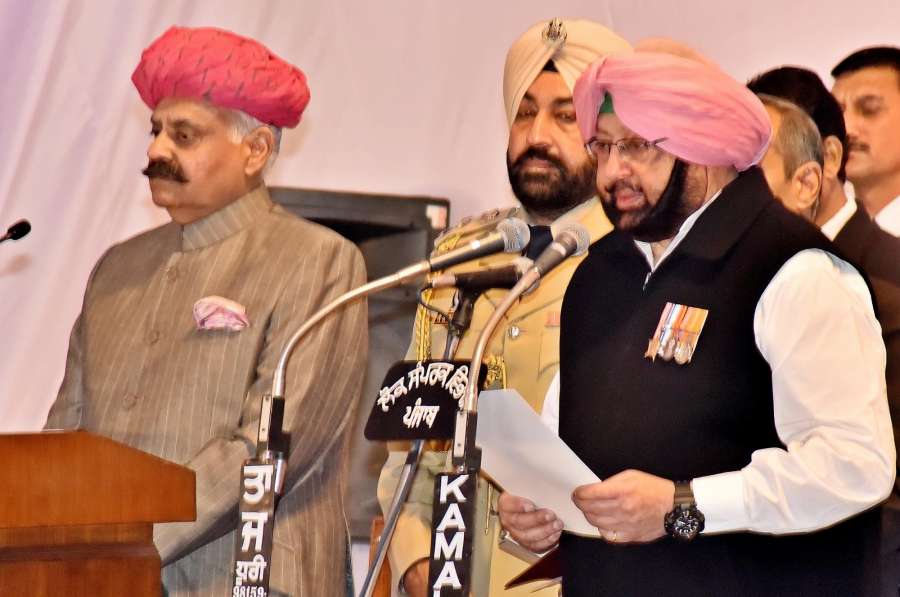 Chandigarh: Punjab Governor VP Singh administer the oath to Captain Amarinder Singh as Chief Minister of Punjab during the swearing in ceremony in Chandigarh, on March 16, 2017. (Photo: IANS) by .