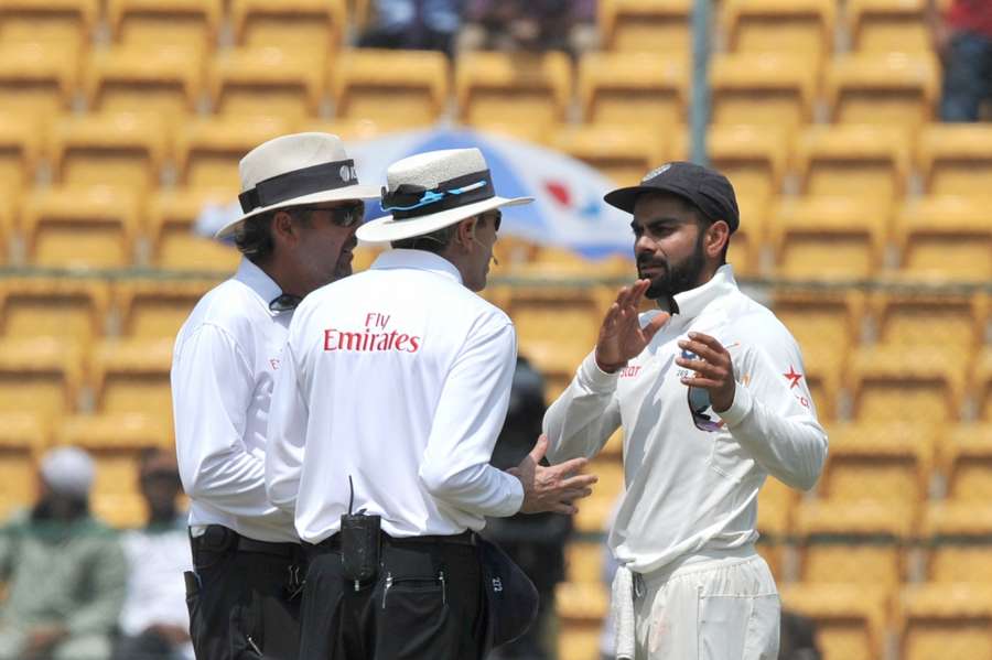 Bengaluru: Indian captain Virat Kohli talks to the umpires during the fourth day of the second test match between India and Australia at M. Chinnaswamy Stadium in Bengaluru on âMarch 7, 2017. (Photo: IANS)ââ by .