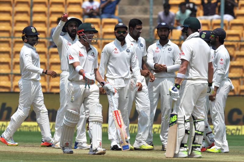 Bengaluru: Indian cricketers celebrate fall of David Warner's wicket during the fourth day of the second test match between India and Australia at M. Chinnaswamy Stadium in Bengaluru on âMarch 7, 2017. (Photo: IANS)ââ by .