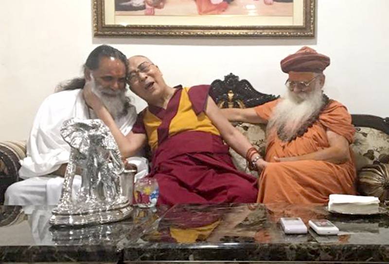 Mathura: Tibetan spiritual leader Dalai Lama (C) meets Karshni Guru Maha Mandaleshwar Sharnanad Maharaj (R) during his visit to Karshni Ashram Raman Reti in Mathura on March 20, 2017. (Photo: IANS) by . 