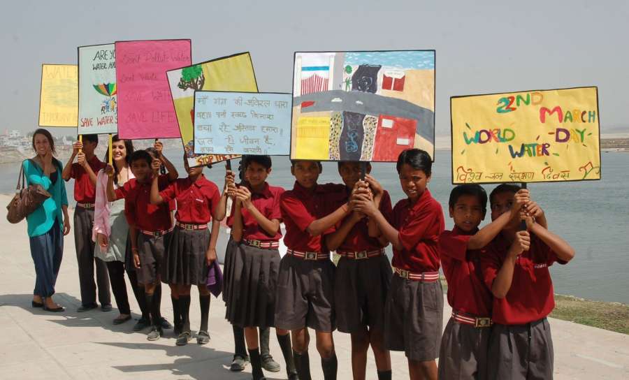 Varanasi: School students holding placards participate in an awareness programme organised on World Water Day on the banks of Ganga river in Varanasi on March 22, 2017. (Photo: IANS) by .