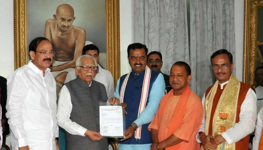 Lucknow: BJP's Uttar Pradesh Chief Minister designate Yogi Adityanath with Deputy Chief Ministers designate Keshav Prasad Maurya and Dinesh Sharma (R) meets Uttar Pradesh Governor Ram Naik, stakes claim to form the government, in Lucknow on March 17, 2017. Also seen Union Minister For Urban Development And Poverty Alleviation M Venkaiah Naidu. (Photo: IANS) by . 