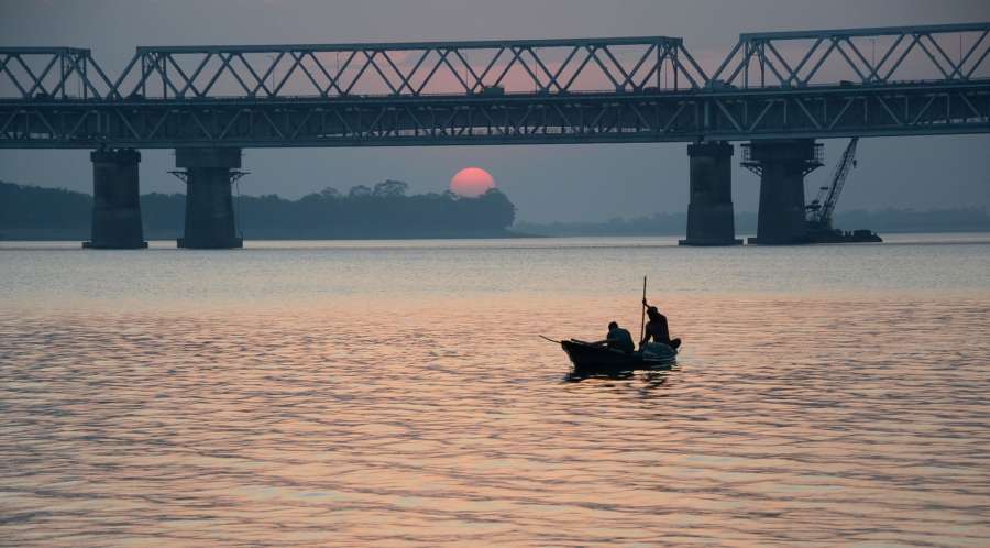 Guwahati: Fishermen return home at sunset after a day of fishing on the banks of Brahmaputra River in Guwahati on Dec 30, 2016. (Photo: IANS) by .