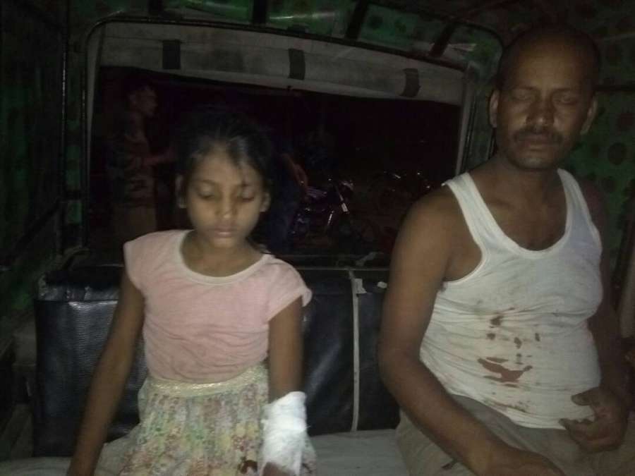 Tinsukia: Yogendra Pratap Singh and his minor daughter who were injured after suspected militants hurled a grenade at their residence in Tinsukia district of Assam on May 4, 2017. (Photo: IANS) by .