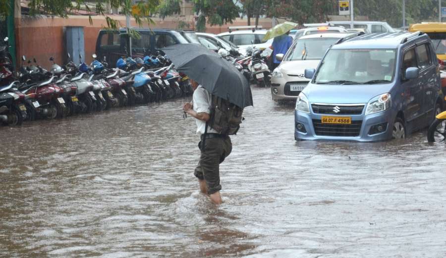 Panaji: A man wades through water logged streets of Panaji after pre monsoon showers lashed the city on May 31, 2017. (Photo: IANS) by . 