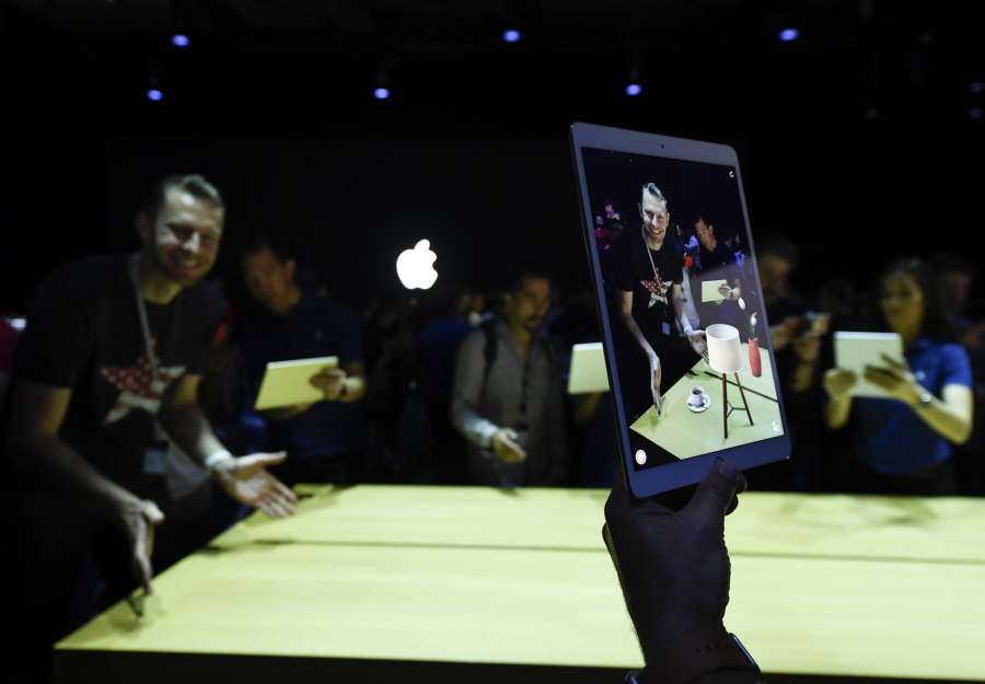 SAN JOSE, June 6, 2017 (Xinhua) -- People try iPad Pro during an event to announce new products at the Worldwide Developers Conference (WWDC) in San Jose, California, the United States, on June 5, 2017. Apple Inc. introduced Monday a music speaker, its first new hardware since Apple Watch was rolled out two years ago, at an annual gathering of software developers. (Xinhua/IANS) (hy) by . 
