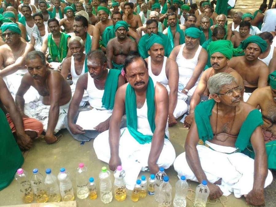 New Delhi: Tamil Nadu farmers protest with bottles of urine to press for their demands at Jantar Mantar in New Delhi on April 22, 2017. Tamil Nadu farmers on Saturday drank their own urine to draw the Centre's attention to the drought in their state and other demands. (Photo: IANS) by . 