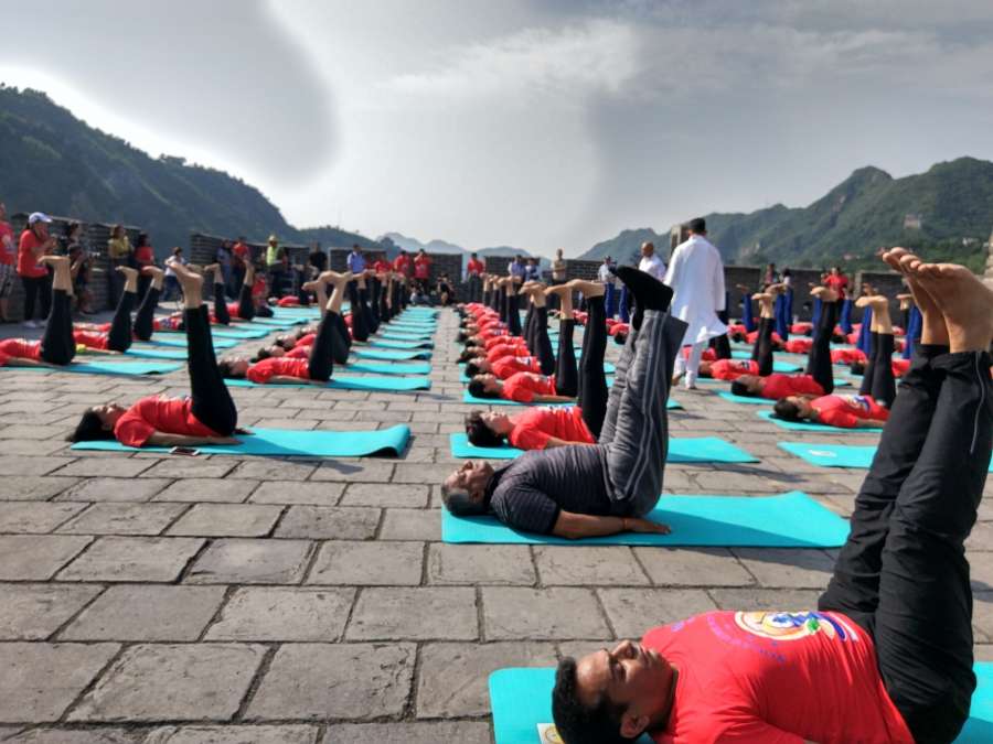 Beijing: Union MoS External Affairs Gen (Retd.) VK Singh performs yoga on the Great Wall of China on the eve of International Yoga Day, on June 20, 2017. (Photo: Gaurav Sharma/IANS) by . 