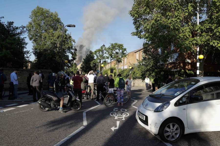 LONDON, June 14, 2017 (Xinhua) -- People look at an apartment building which is engulfed by a massive fire in western London, Britain, June 14, 2017. A massive fire engulfed a 27-story apartment building in western London early Wednesday three hours after police received the first report of the blaze. (Xinhua/Han Yan/IANS) by .