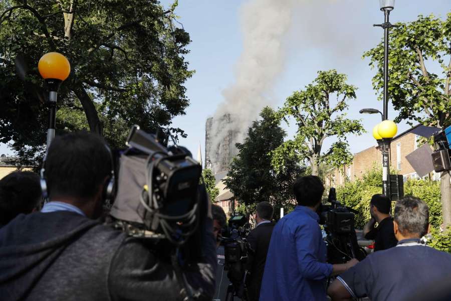 LONDON, June 14, 2017 (Xinhua) -- Media staff work near an apartment building which is engulfed by a massive fire in western London, Britain, June 14, 2017. A massive fire engulfed a 27-story apartment building in western London early Wednesday three hours after police received the first report of the blaze. (Xinhua/Han Yan/IANS) by . 