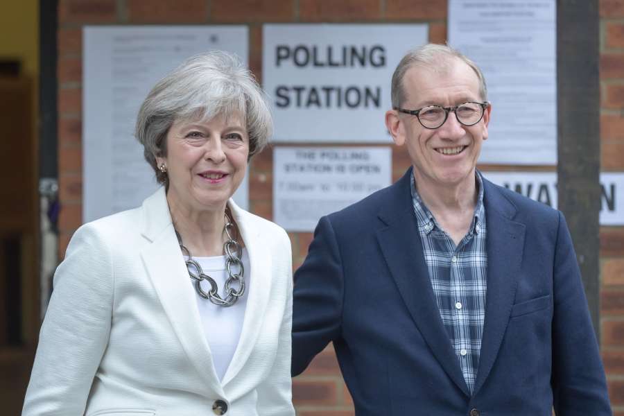 SONNING (BRITAIN), June 8, 2017 (Xinhua) -- Britain's Prime Minister and leader of the Conservative Party Theresa May (L) and her husband walk out from the polling station after casting their ballots for the general election in Sonning, Britain on June 8, 2017. (Xinhua/Tim Ireland/IANS) (lrz) by . 