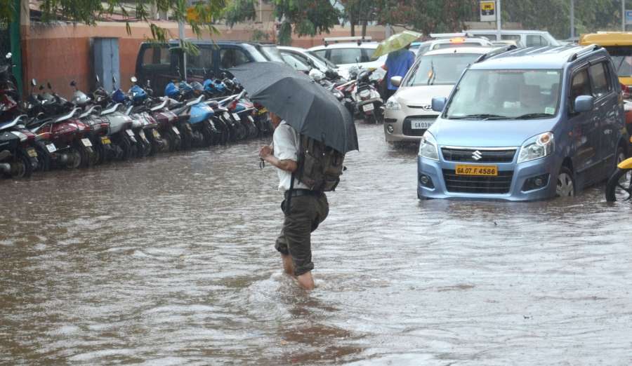 Panaji: A man wades through water logged streets of Panaji after pre monsoon showers lashed the city on May 31, 2017. (Photo: IANS) by .