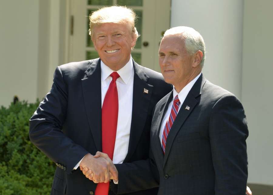 WASHINGTON, June 1, 2017 (Xinhua) -- U.S. President Donald Trump (L) shakes hands with U.S. Vice President Mike Pence before delivering a speech at the White House in Washington D.C., capital of the United States, on June 1, 2017. U.S. President Donald Trump said on Thursday that he has decided to pull the United States out of the Paris Agreement, a landmark global pact to fight climate change. (Xinhua/Mike Theiler/IANS) by . 