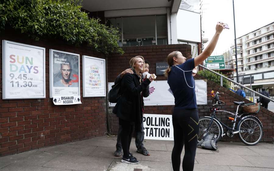 LONDON, June 8, 2017 (Xinhua) -- People pose for a selfie outside a polling station in London, Britain, June 8, 2017. Polling stations across Britain opened early Thursday as voters started to make their decision in the snap general election dubbed by some media as the most crucial one in a generation. (Xinhua/Han Yan/IANS) (zjy) by . 