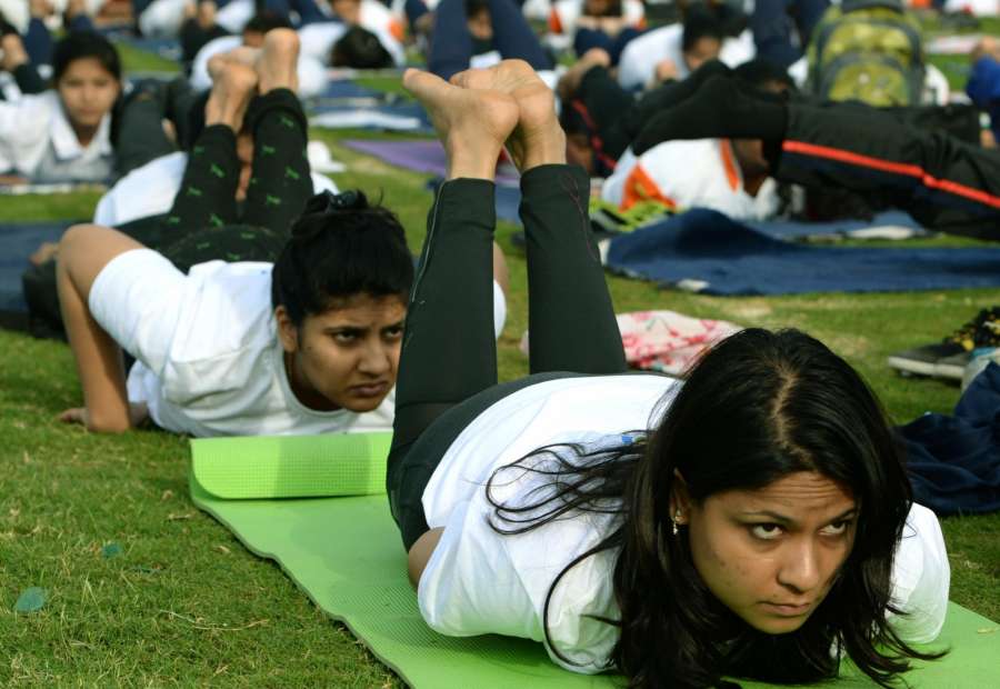 People practice Yoga Asans -postures- on International Yoga Day in Bengaluru on June 21, 2017. (Photo: IANS) by . 