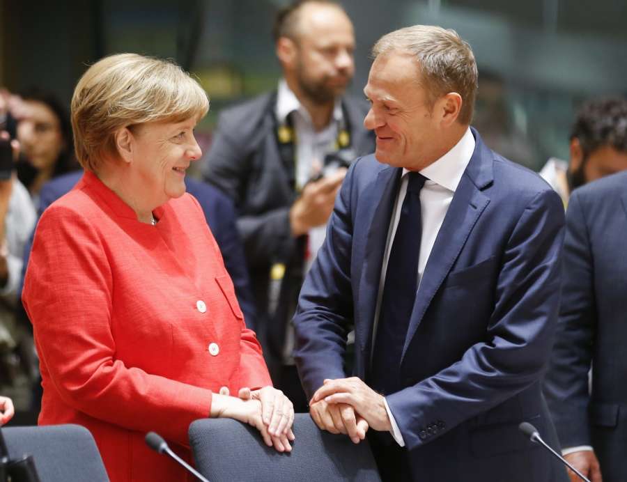 Brussels: German Chancellor Angela Merkel (L) talks with European Council President Donald Tusk at second day's EU Summit in Brussels, Belgium, June 23, 2017. (Xinhua/Ye Pingfan/IANS) by . 