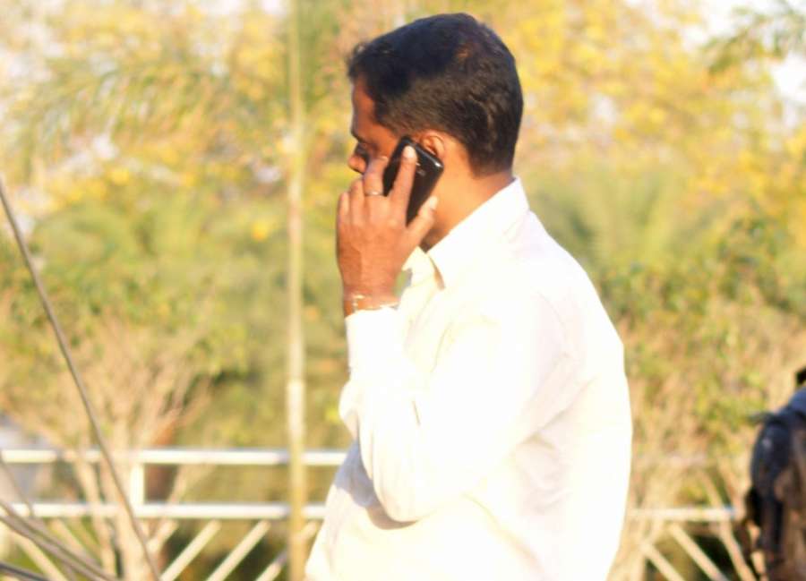 A man busy talking over his mobile phone. (File Photo: IANS) by . 