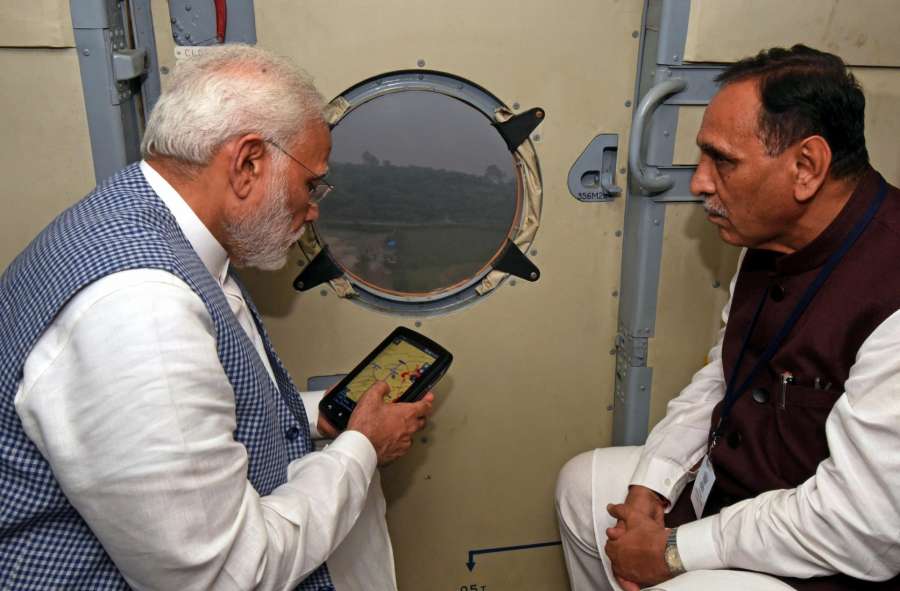 Gujarat: Prime Minister Narendra Modi conducts aerial survey of flood affected areas of Gujarat on July 25, 2017. Also seen Gujarat Chief Minister Vijay Rupani. (Photo: IANS) by .