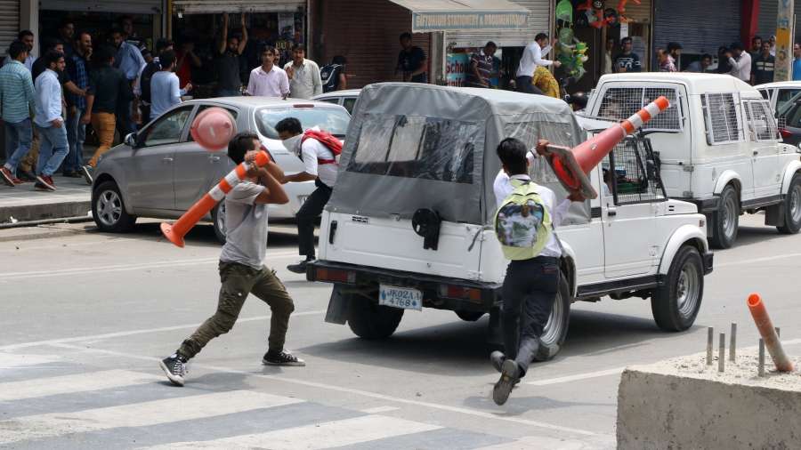 Srinagar: Students attack a vehicle belonging to security personnel in Srinagar after a top Pakistani militant who carried a reward of Rs 15 lakh on his head was killed along with a local associate in fighting with security forces on Aug 1, 2017. (Photo: IANS) by .