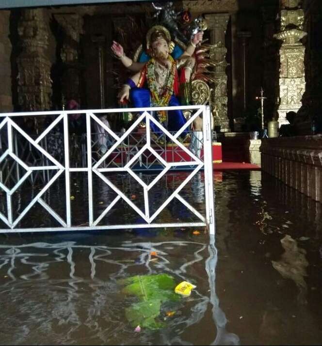 Mumbai: A view of a flooded Ganesh pandal after rains lashed Mumbai on Aug 29, 2017. (Photo: IANS) by .