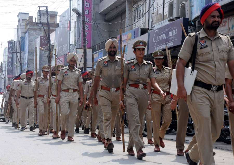 Bathinda: Punjab police personnel conduct flag march ahead of the Aug 25 verdict of the CBI court in the rape case against Dera Saccha Sauda chief Gurmeet Ram Rahim Singh in Bathinda on Aug 23, 2017. (Photo: IANS) by .