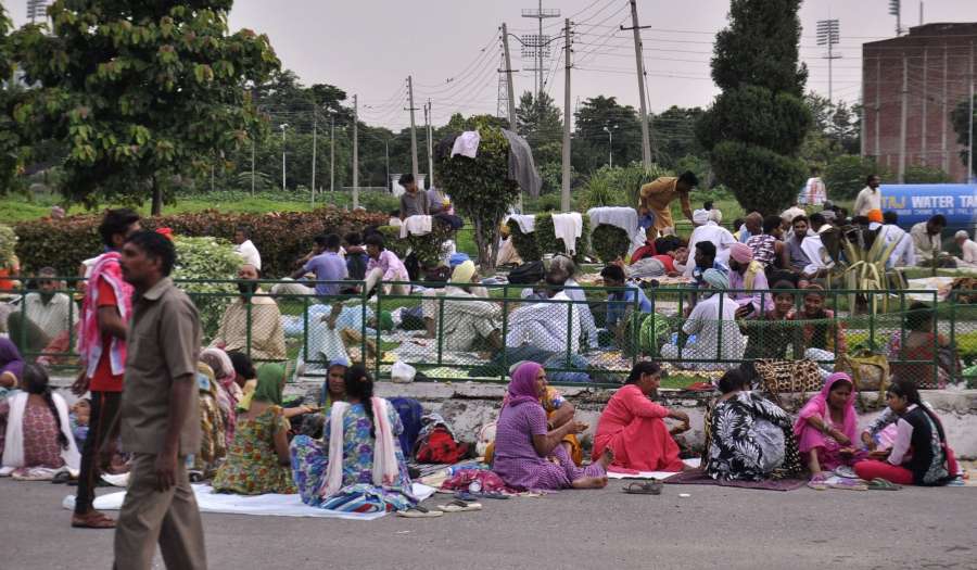 Panchkula: Followers of Dera Sacha Sauda chief Gurmeet Ram Rahim Singh gather ahead of the Aug 25 verdict of the CBI court in the rape case against Dera Sacha Sauda chief Gurmeet Ram Rahim Singh in the Panchkula district of Haryana on Aug 24, 2017. (Photo: IANS) by .