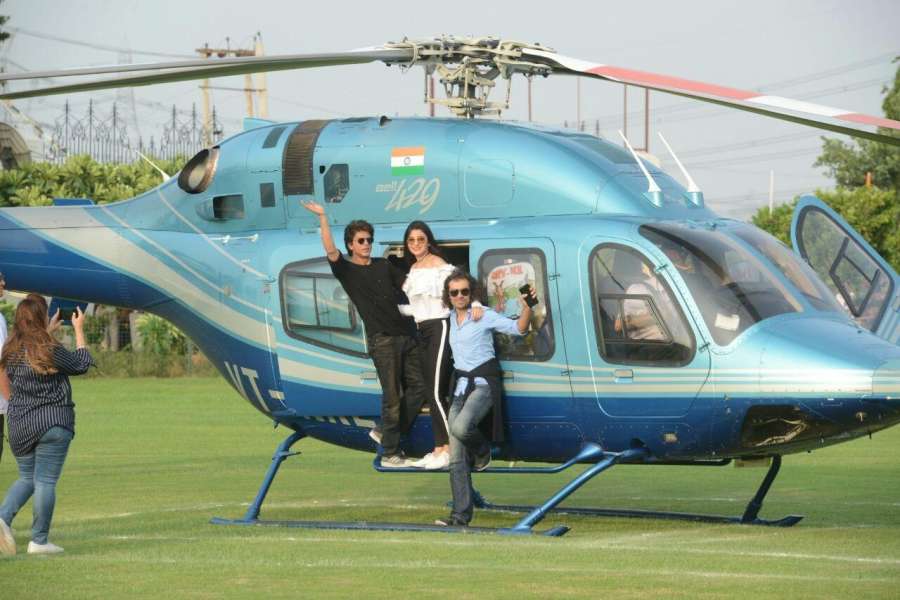 Gurugram: Actors Anushka Sharma and Shah Rukh Khan along with Filmmaker Imtiaz Ali deboard a helicopter at a Gurugram University where they arrived to promote their upcoming film "Jab Harry Met Sejal" on Aug 3, 2017. (Photo: IANS) by .