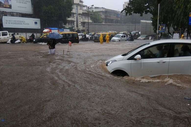 Mumbai: Vehicles struggle through the waterlogged streets after rains lashed Mumbai on Aug 29, 2017. (Photo: IANS) by .