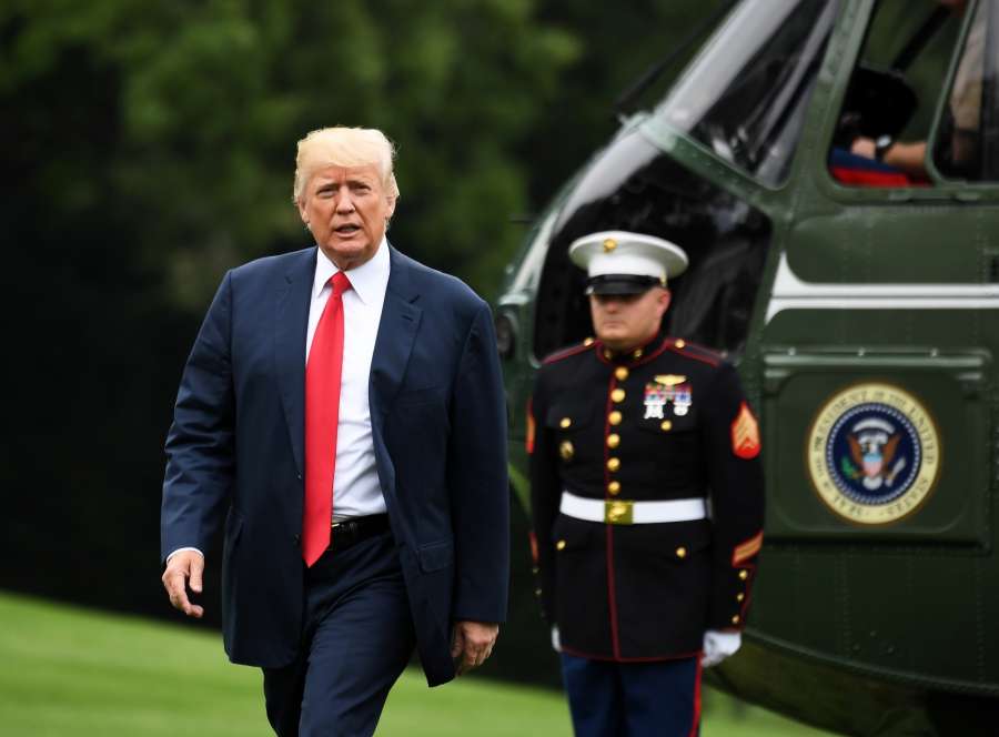 WASHINGTON, Aug. 14, 2017 (Xinhua) -- U.S. President Donald Trump (L) walks to his office from Marine One as he returns to the White House in Washington D.C., the United States, on Aug. 14, 2017. U.S. President Donald Trump on Monday directed the U.S. trade representative (USTR) to examine alleged China's intellectual property practices, despite worries about potential harms to China-U.S. trade ties. (Xinhua/Yin Bogu/IANS) by . 