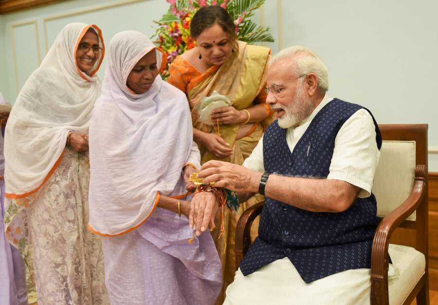 New Delhi: Widows tie ‘Rakhi’ on Prime Minister Narendra Modi’s wrist on ‘Raksha Bandhan’ in New Delhi on Aug 7, 2017. (Photo: IANS/PIB) by .
