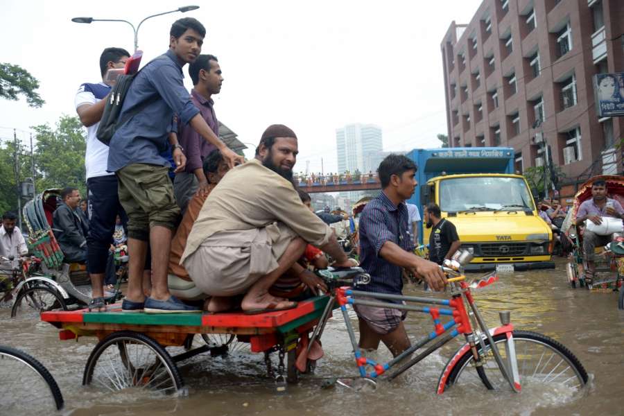 DHAKA, July 26, 2017 (Xinhua) -- People wade through a water-logged road after heavy rains in Dhaka, Bangladesh, July 26, 2017. (Xinhua/Salim Reza/IANS) by .