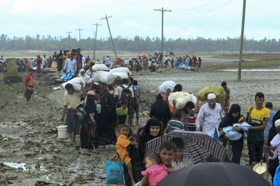 Dakhinpara: Rohingya refugees arrive at Shah Porir Dwip in Dakhinpara ofBangladesh from Rasidong in Myanmar, on Sept 13, 2017. (Photo: bdnews24/IANS) by . 