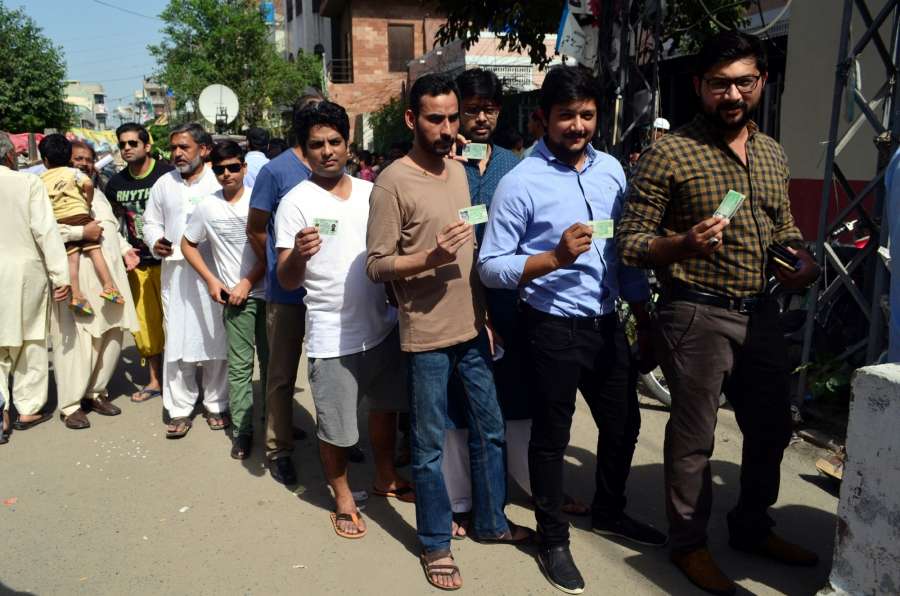 LAHORE, Sept. 18, 2017 (Xinhua) -- People show their identity cards as they wait in a queue to cast their votes during the parliamentary by-election in eastern Pakistan's Lahore, on Sept. 17, 2017. Ousted Pakistani Prime Minister Nawaz Sharif's wife Kulsoom Nawaz has won parliamentary seat in a neck-and-neck by-election, according to unofficial results announced early Monday. (Xinhua/Jamil Ahmed/IANS) by .